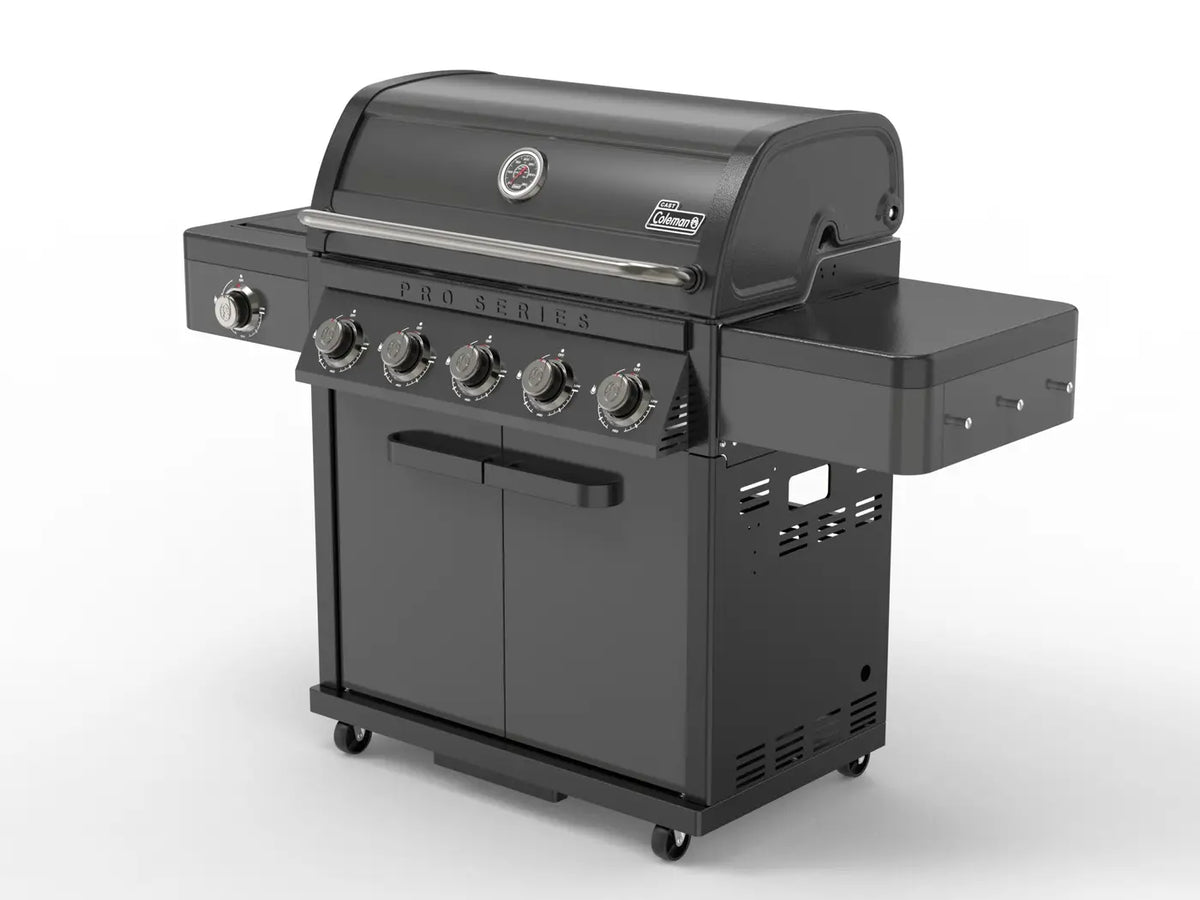 Coleman Pro Series gas bbq with side burner, angled view showing cart doors and wheels