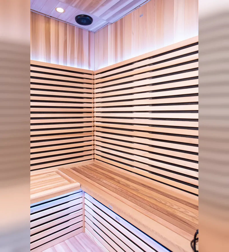 Inside the Chill Bunny indoor infrared sauna showing cedar slats, bench and lighting