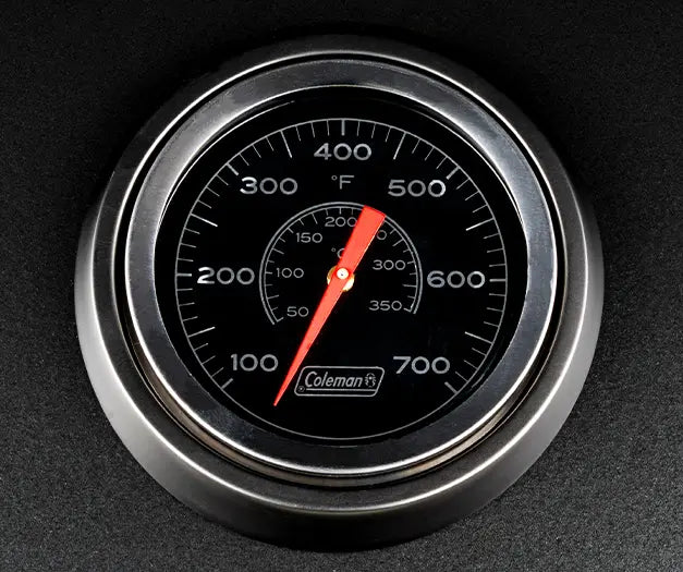 Coleman Pro Series bbq temperature gauge close-up, 100 to 700 degrees Fahrenheit dial