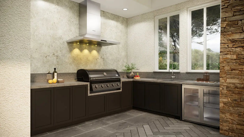 Coleman Pro Series built in bbq set into dark cabinetry in an outdoor kitchen with extraction hood