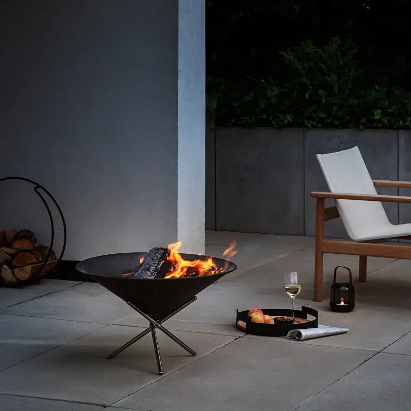 firecone-buring-on-patio-at-night