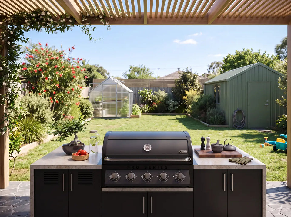 Backyard alfresco outdoor kitchen with Coleman Pro Series built-in BBQ, greenhouse and garden shed